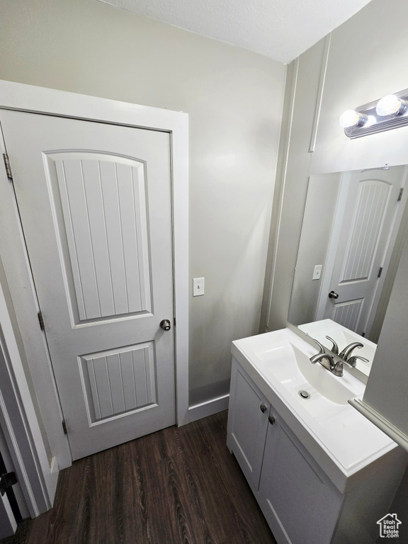 Bathroom with wood finished floors and vanity