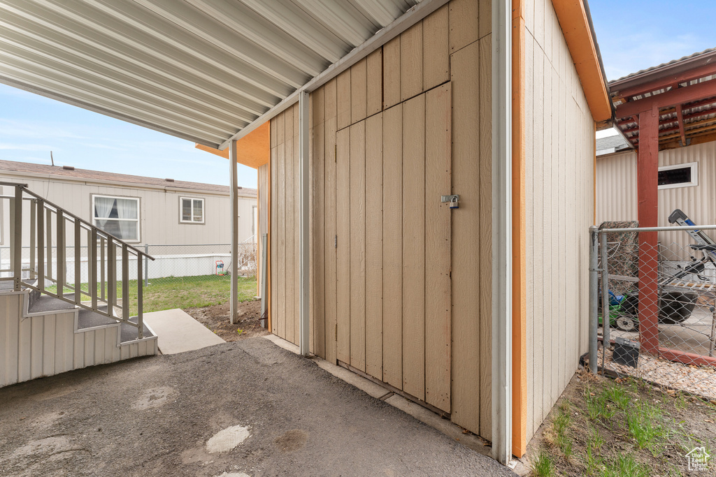 View of outbuilding featuring fence