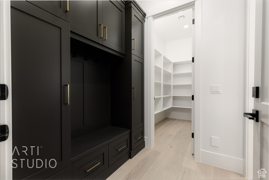 Mudroom featuring light wood-style floors and baseboards