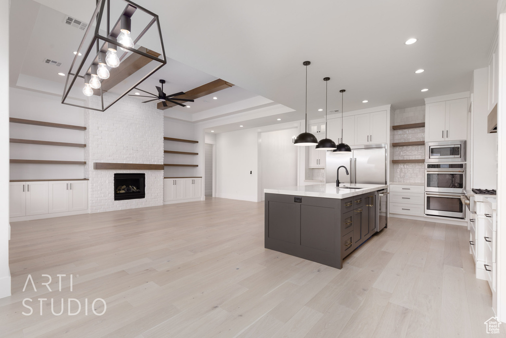 Kitchen with open shelves, built in appliances, white cabinetry, a ceiling fan, and recessed lighting