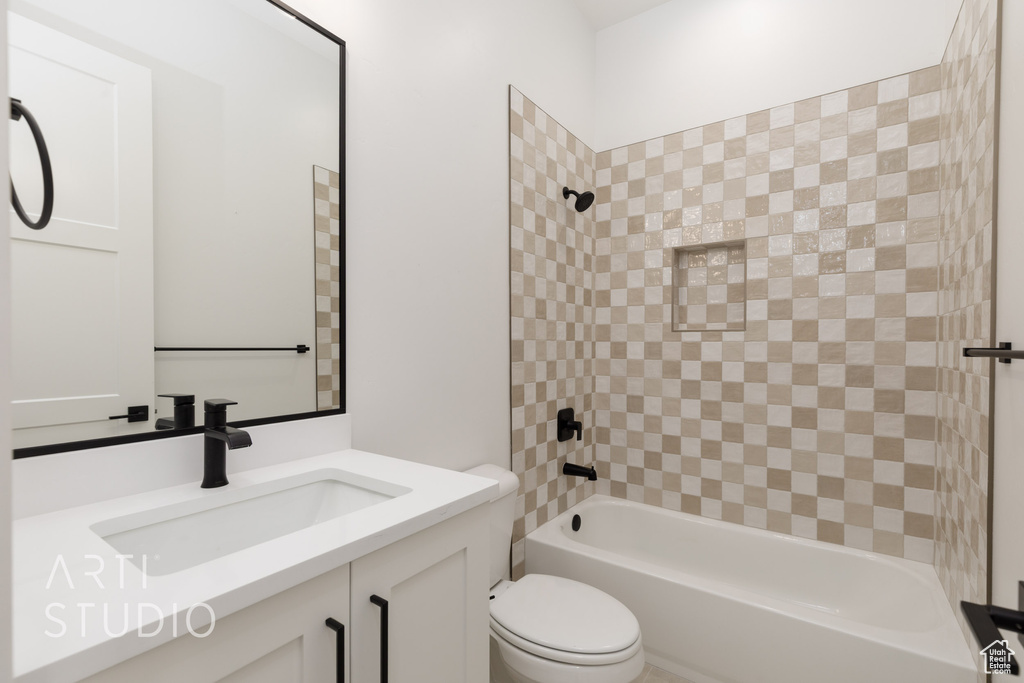 Full bath with washtub / shower combination, vanity, and toilet