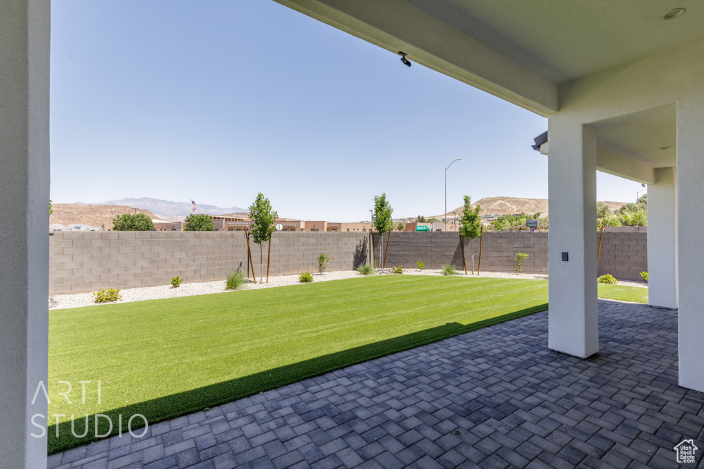 View of yard with a mountain view and a patio area