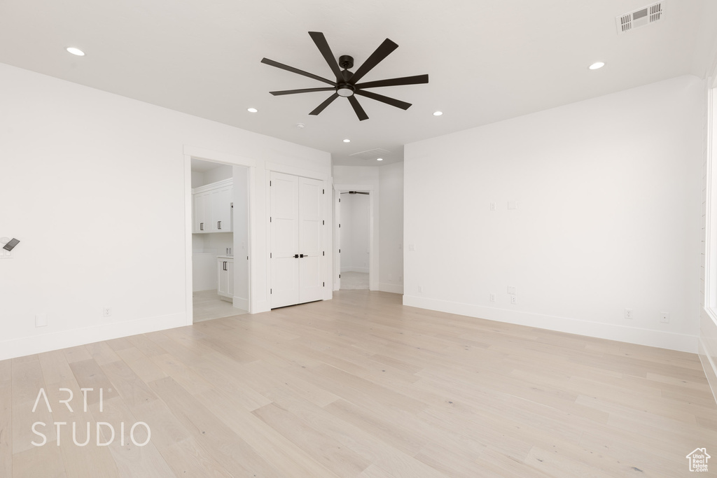 Spare room with ceiling fan, light wood-style floors, recessed lighting, and baseboards