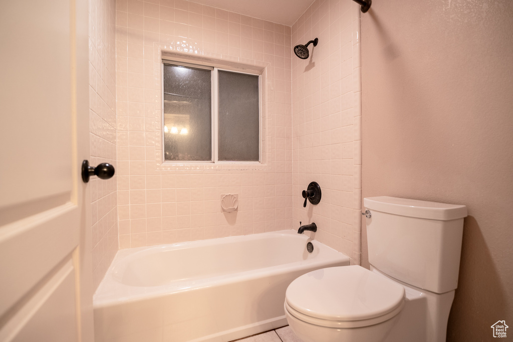 Full bathroom featuring toilet and shower / washtub combination