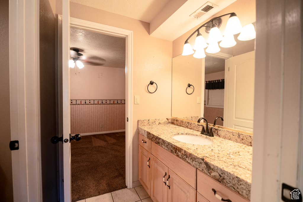 Bathroom featuring tile patterned floors, vanity, a textured ceiling, and ceiling fan