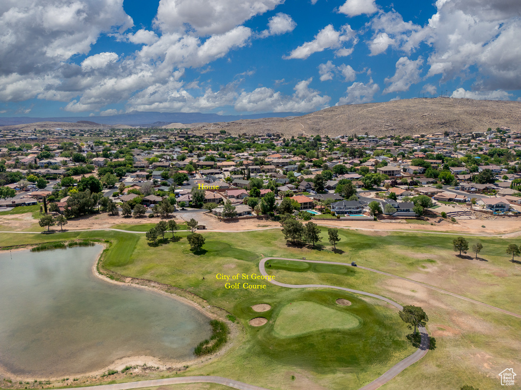 Aerial view of residential area featuring a water and mountain view and a golf course