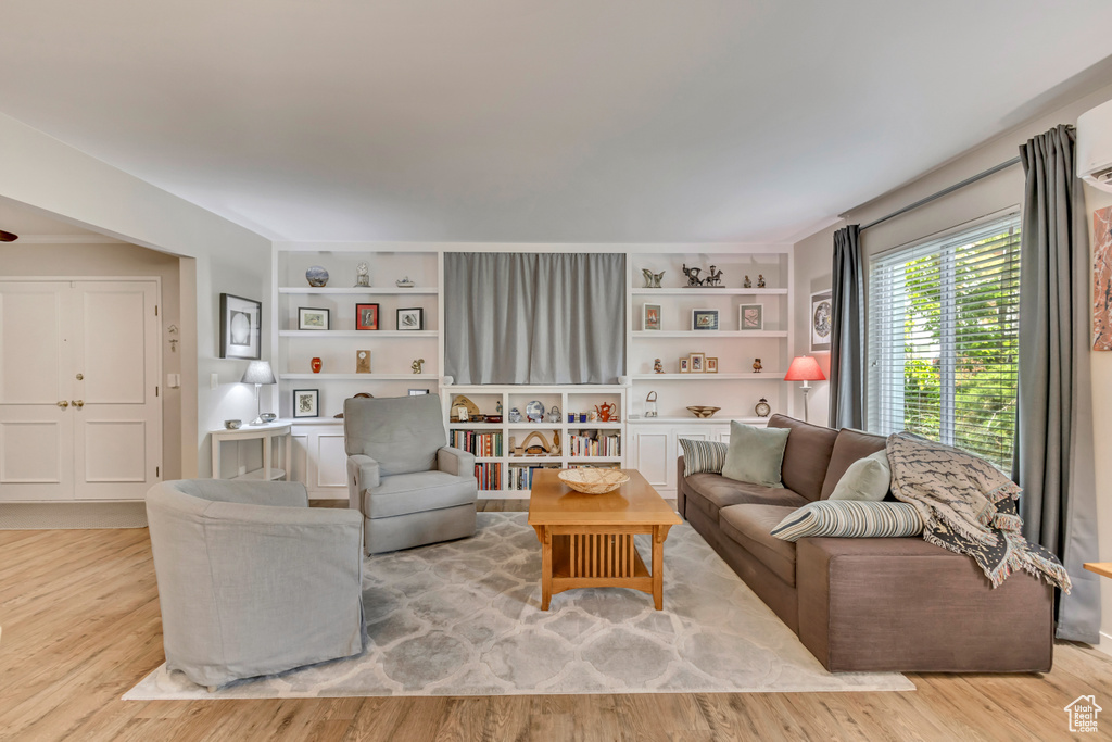 Living room featuring wood finished floors and built in features