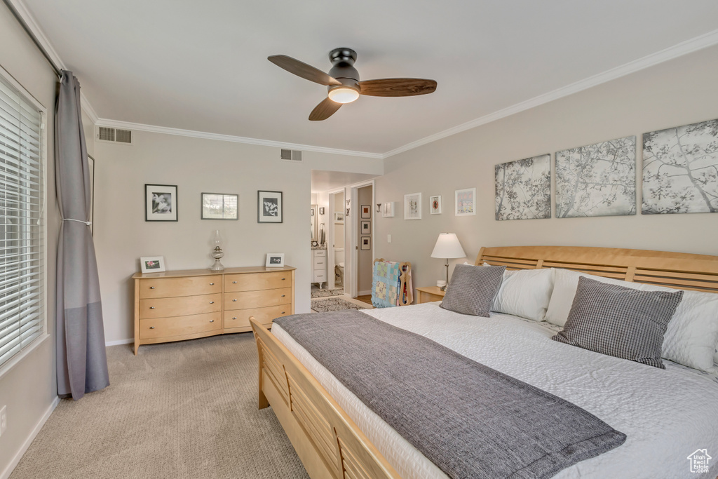 Bedroom featuring ornamental molding, light carpet, baseboards, and a ceiling fan