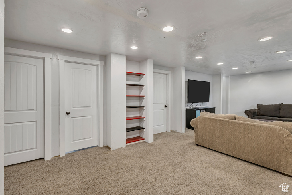 Carpeted living room featuring recessed lighting
