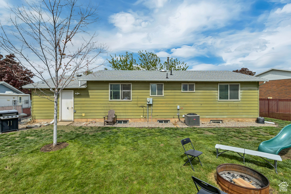 Rear view of property with a playground and central AC