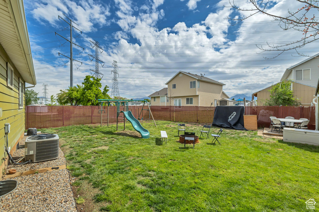 View of yard featuring central AC unit and a playground
