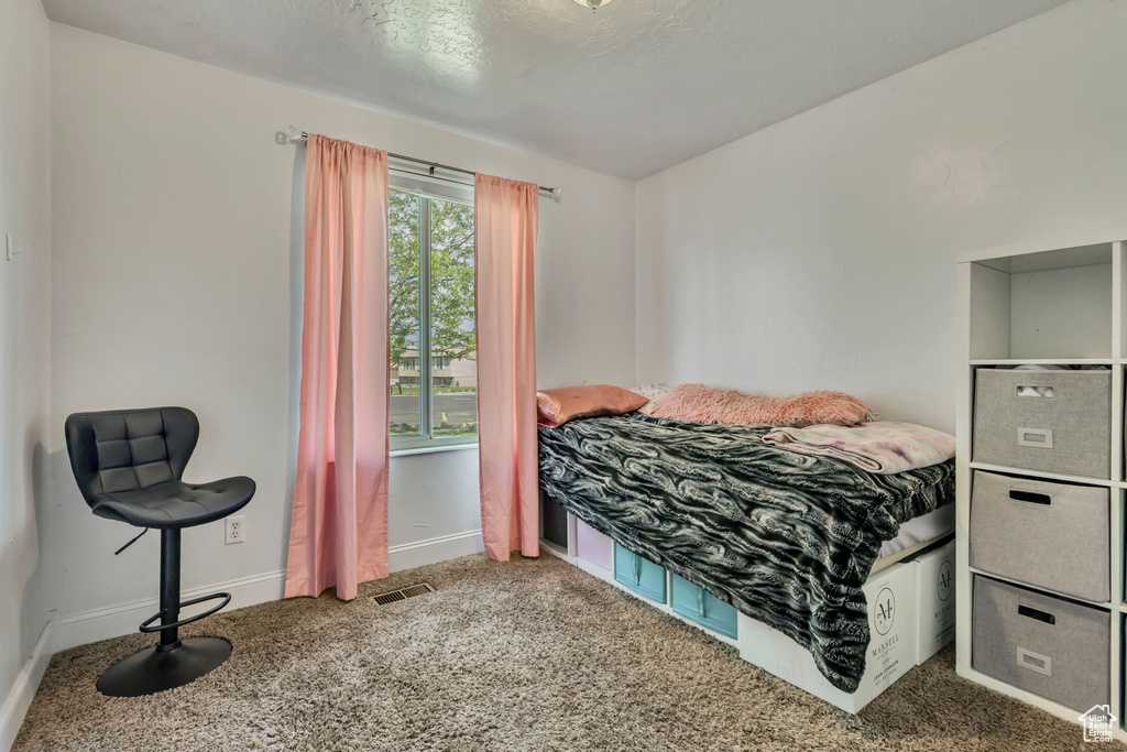 Bedroom with baseboards and carpet