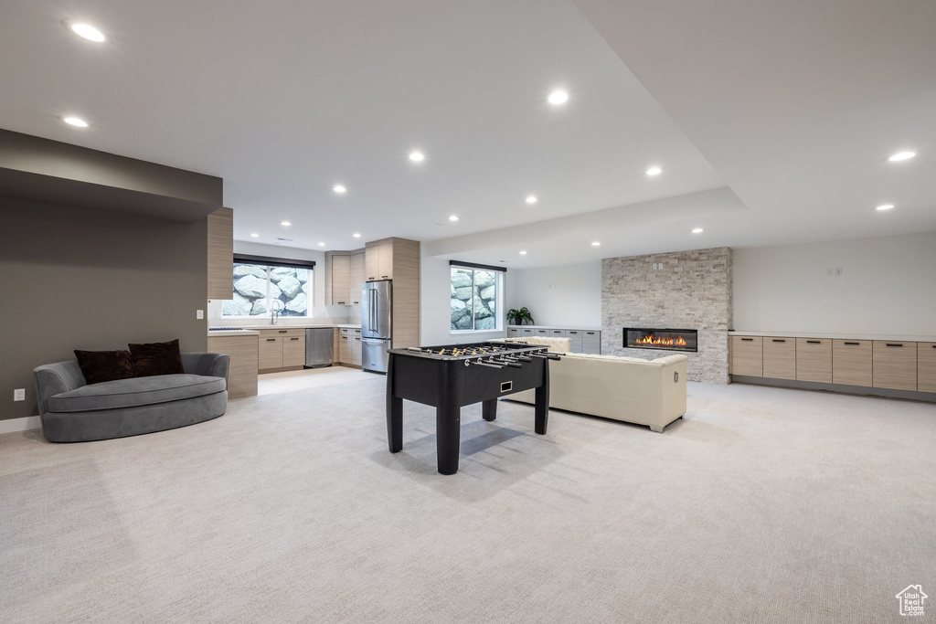 Playroom with light carpet, recessed lighting, and a fireplace