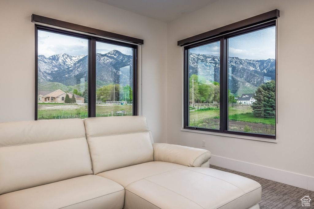 Living room with healthy amount of natural light, a mountain view, and baseboards