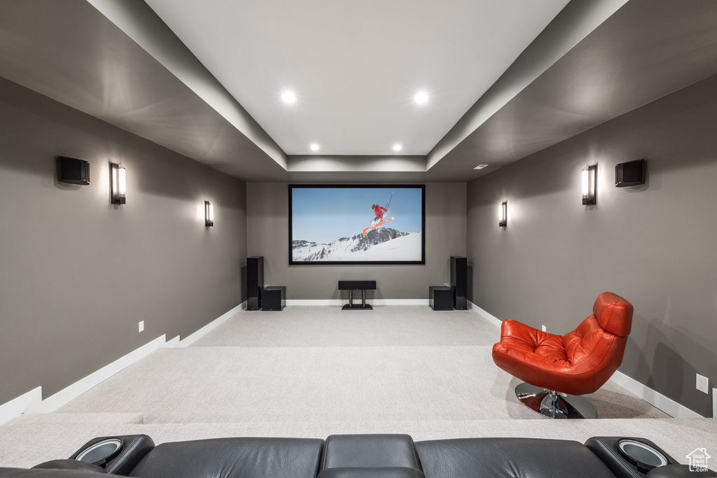 Carpeted home theater room featuring baseboards, recessed lighting, and a raised ceiling
