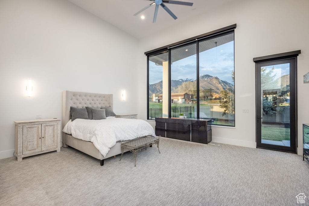 Carpeted bedroom with access to outside, baseboards, a ceiling fan, recessed lighting, and a mountain view