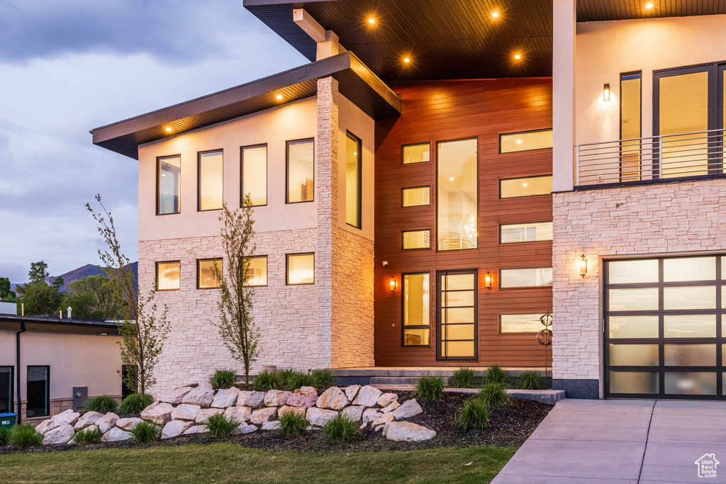Modern home with stone siding and concrete driveway