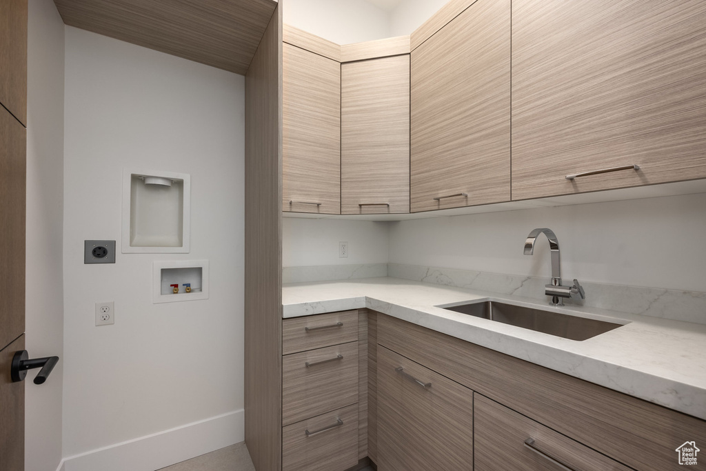 Laundry room with electric dryer hookup, cabinet space, washer hookup, and baseboards