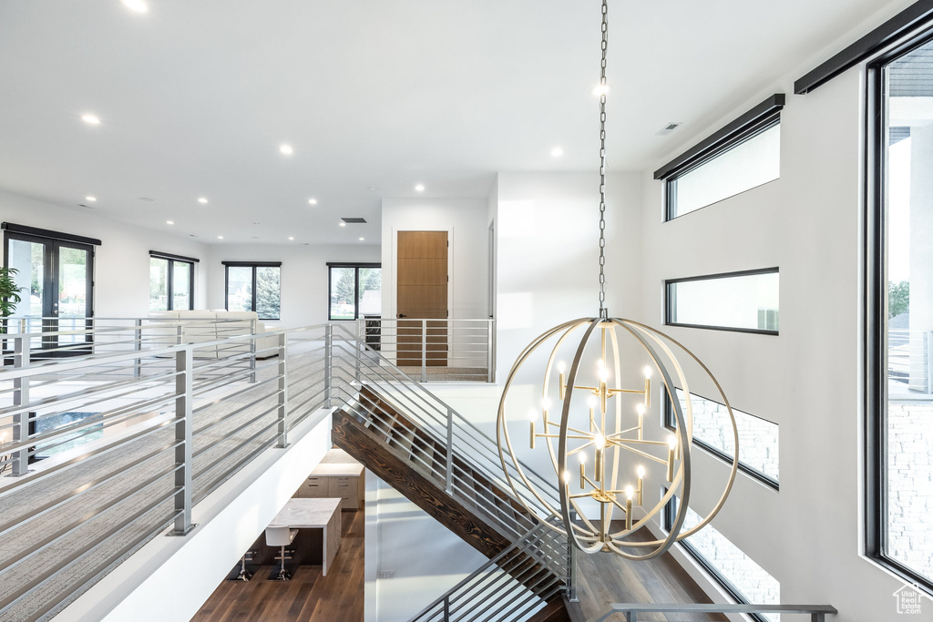 Detailed view of a chandelier, recessed lighting, and wood finished floors