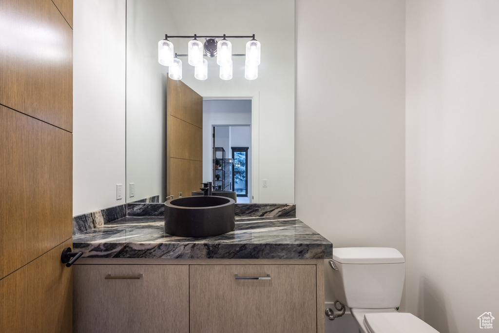 Half bathroom featuring toilet and vanity