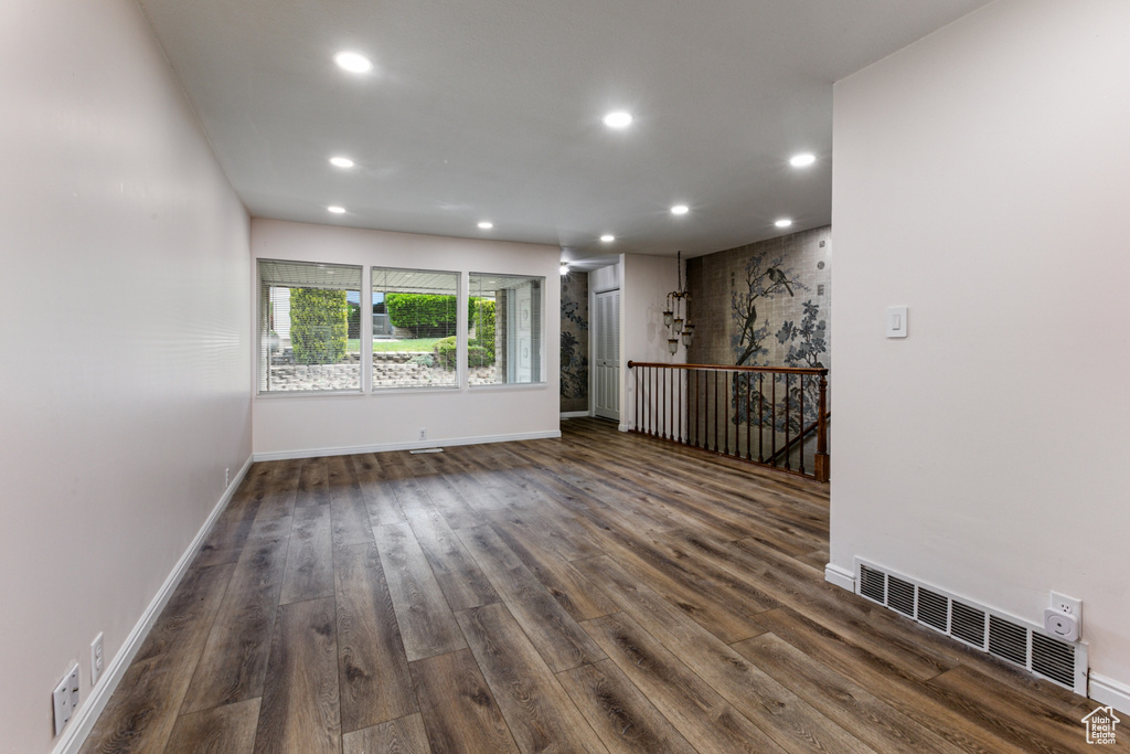Spare room featuring recessed lighting, dark wood finished floors, and baseboards