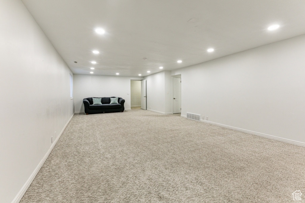 Unfurnished room with recessed lighting, light colored carpet, and baseboards