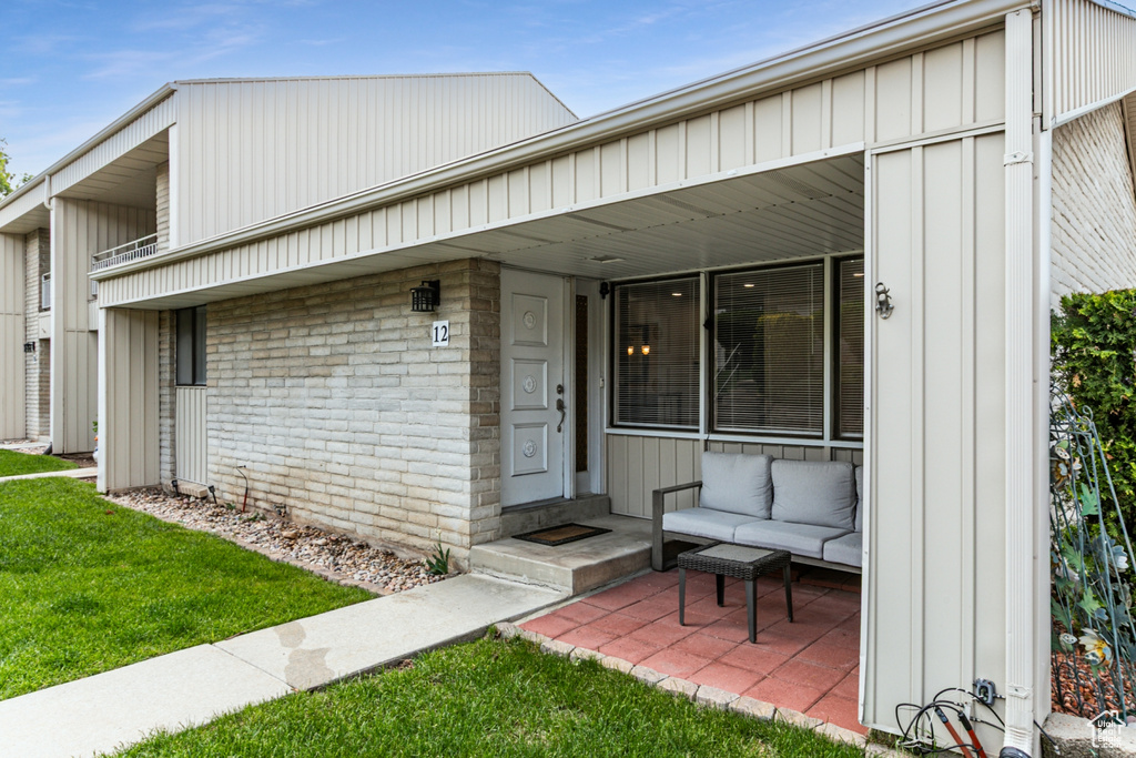 View of front facade featuring board and batten siding and a front lawn