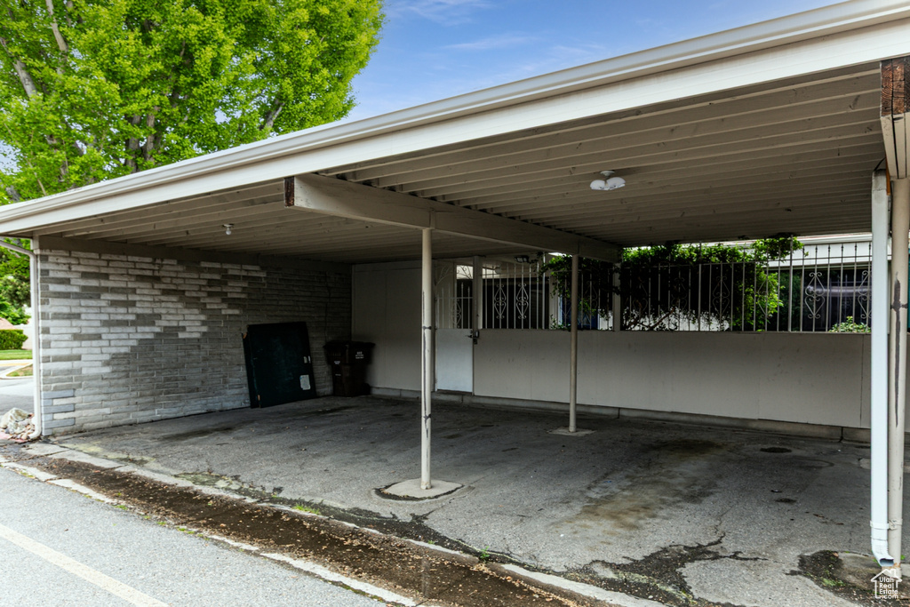View of parking / parking lot with a carport