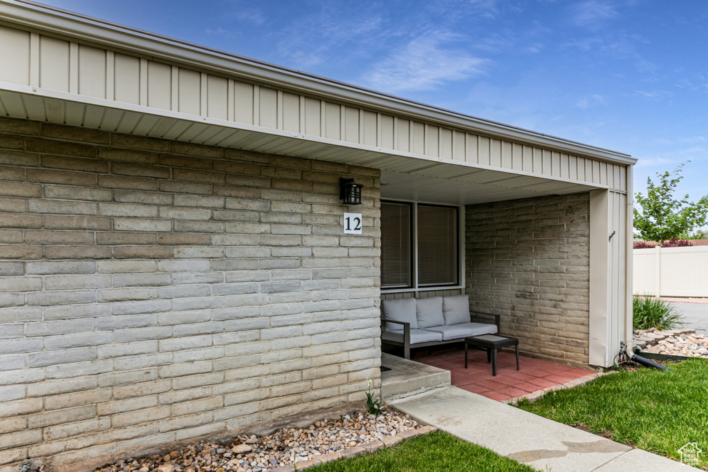 Entrance to property with brick siding and fence