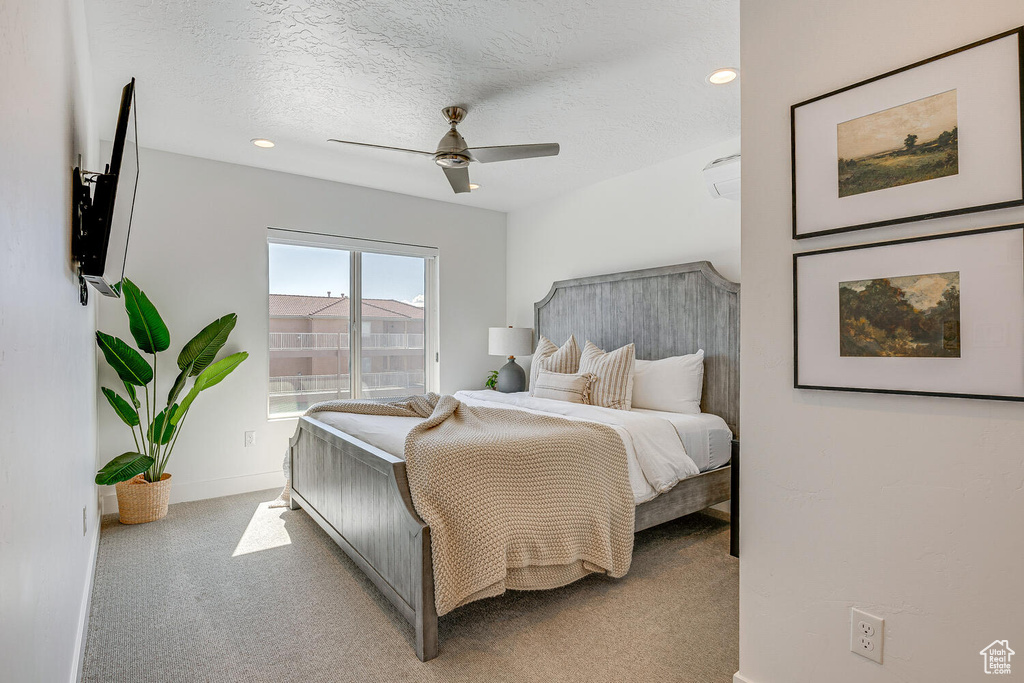 Bedroom featuring carpet floors, a textured ceiling, baseboards, a ceiling fan, and recessed lighting