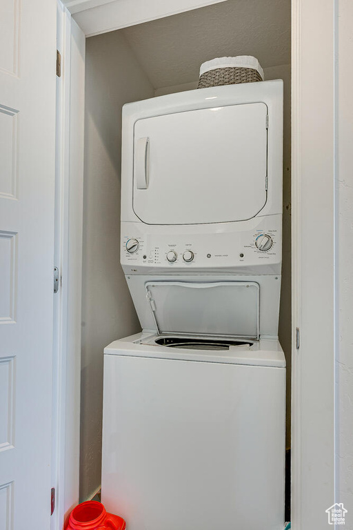 Laundry room featuring stacked washer / drying machine