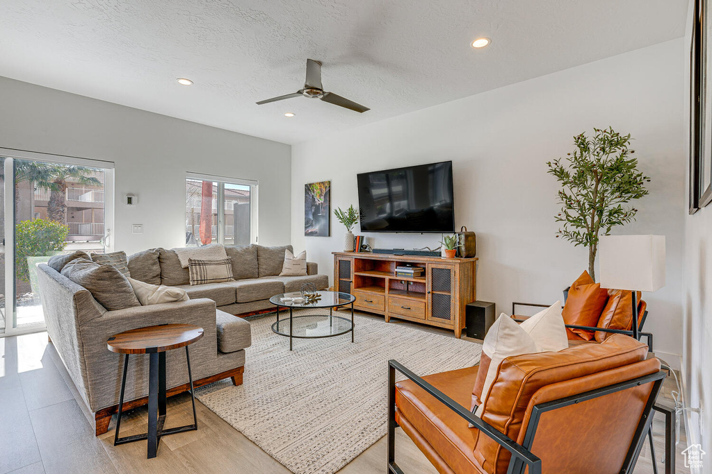 Living area featuring a ceiling fan, light wood finished floors, and recessed lighting
