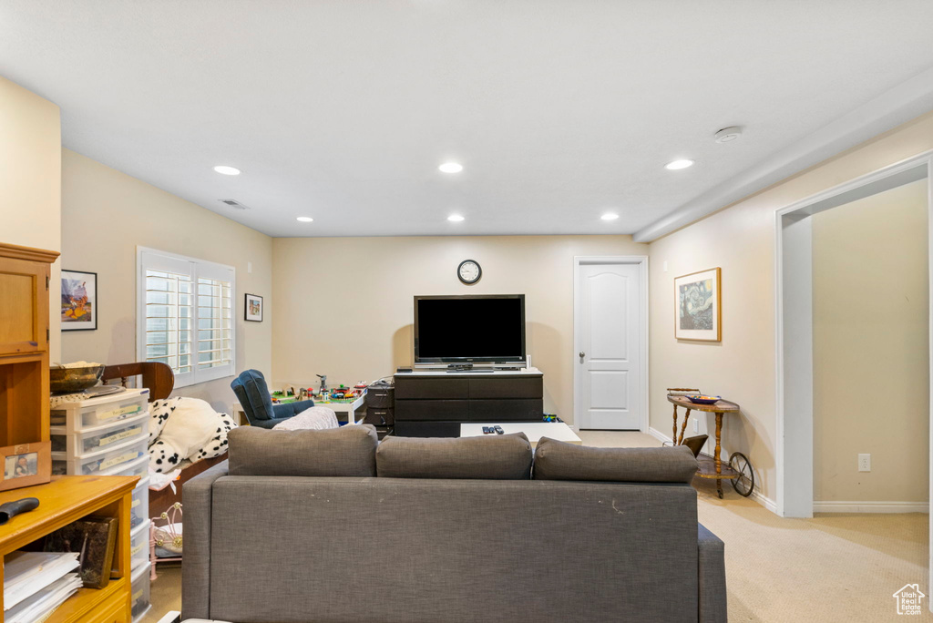 Living room featuring light carpet, recessed lighting, and baseboards