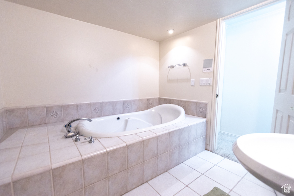 Bathroom featuring tile patterned floors and a bath