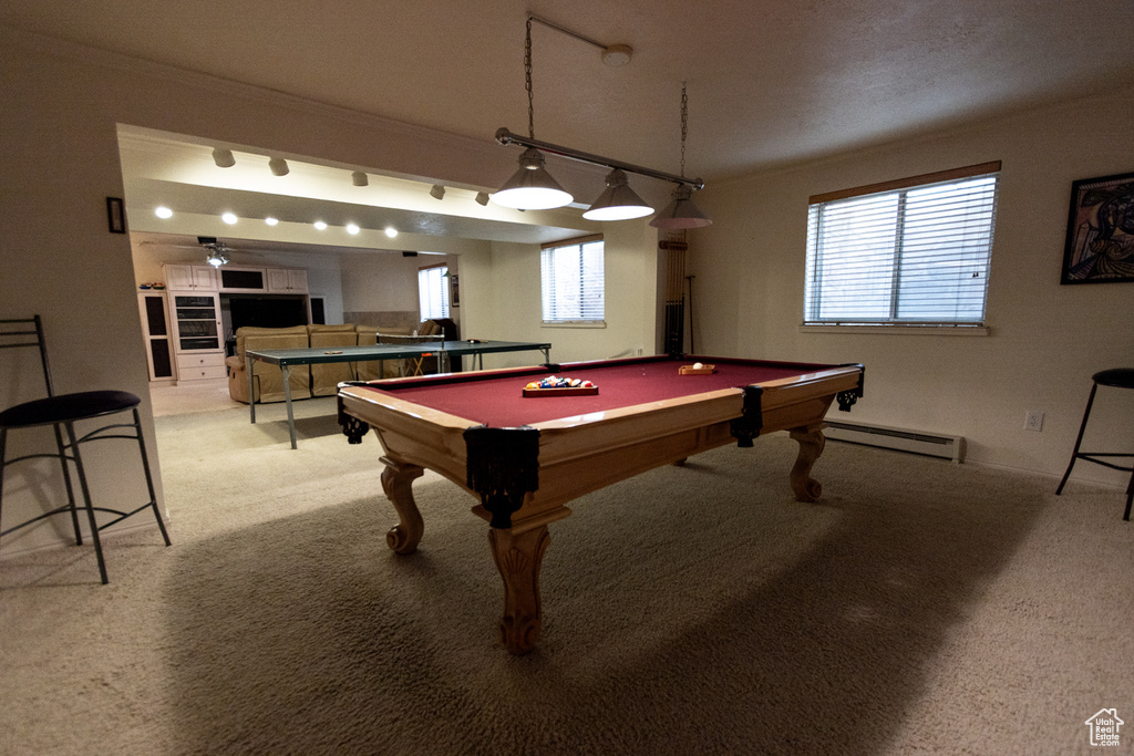 Recreation room featuring crown molding, light colored carpet, pool table, and baseboard heating