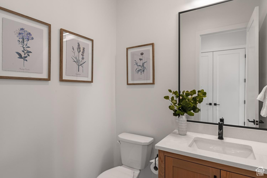 Half bath featuring vanity and toilet