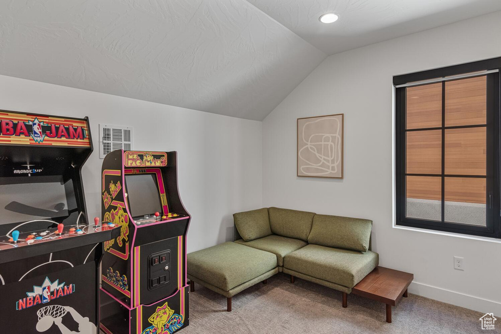 Playroom featuring lofted ceiling, carpet floors, and baseboards