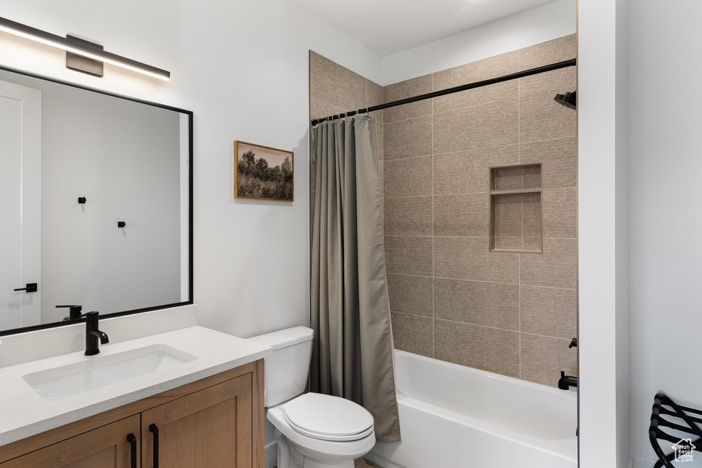 Full bath with toilet, vanity, and shower / tub combo