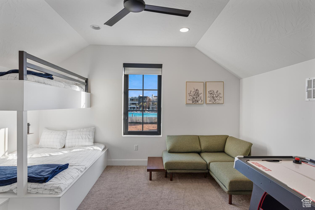 Bedroom with vaulted ceiling, carpet flooring, ceiling fan, and baseboards
