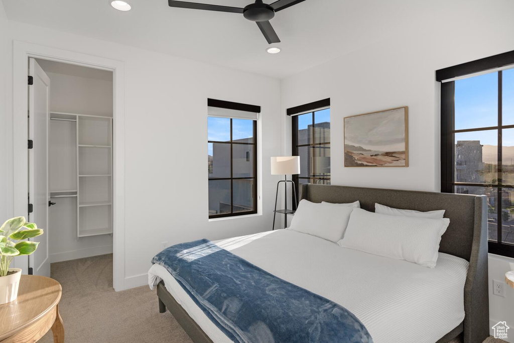 Bedroom with carpet floors, a walk in closet, recessed lighting, a ceiling fan, and a closet