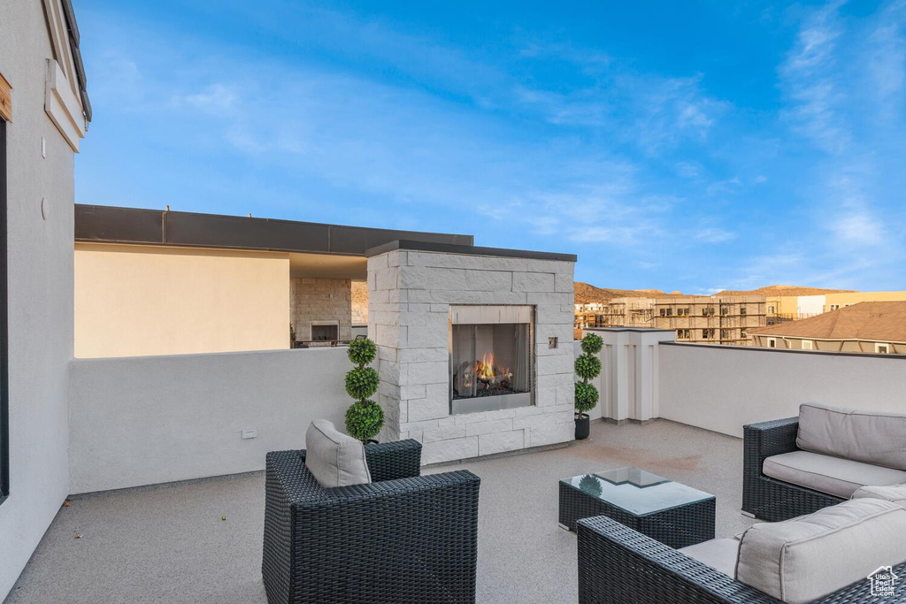 View of patio featuring an outdoor living space with a fireplace