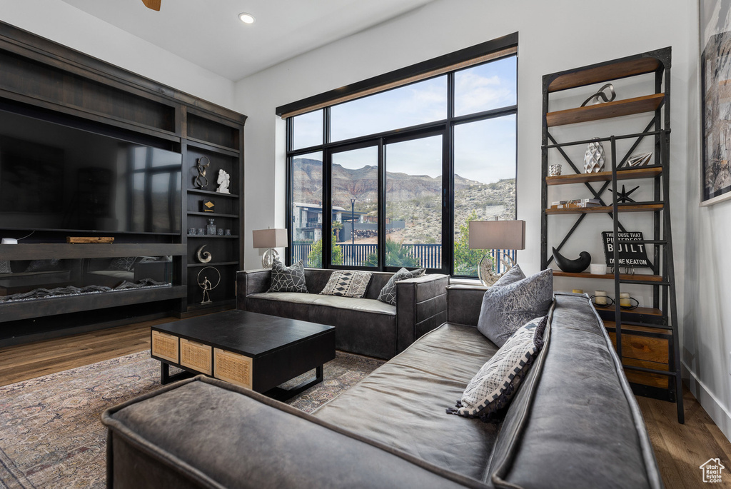 Living room featuring a mountain view, wood finished floors, and recessed lighting