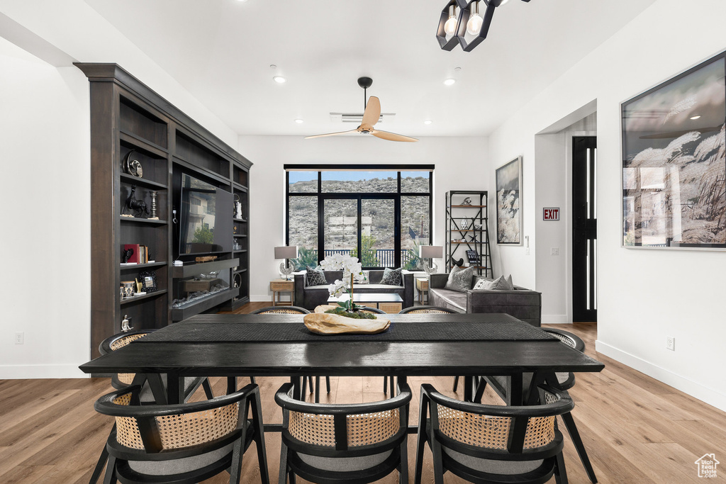 Dining space featuring light wood finished floors, a ceiling fan, recessed lighting, and baseboards