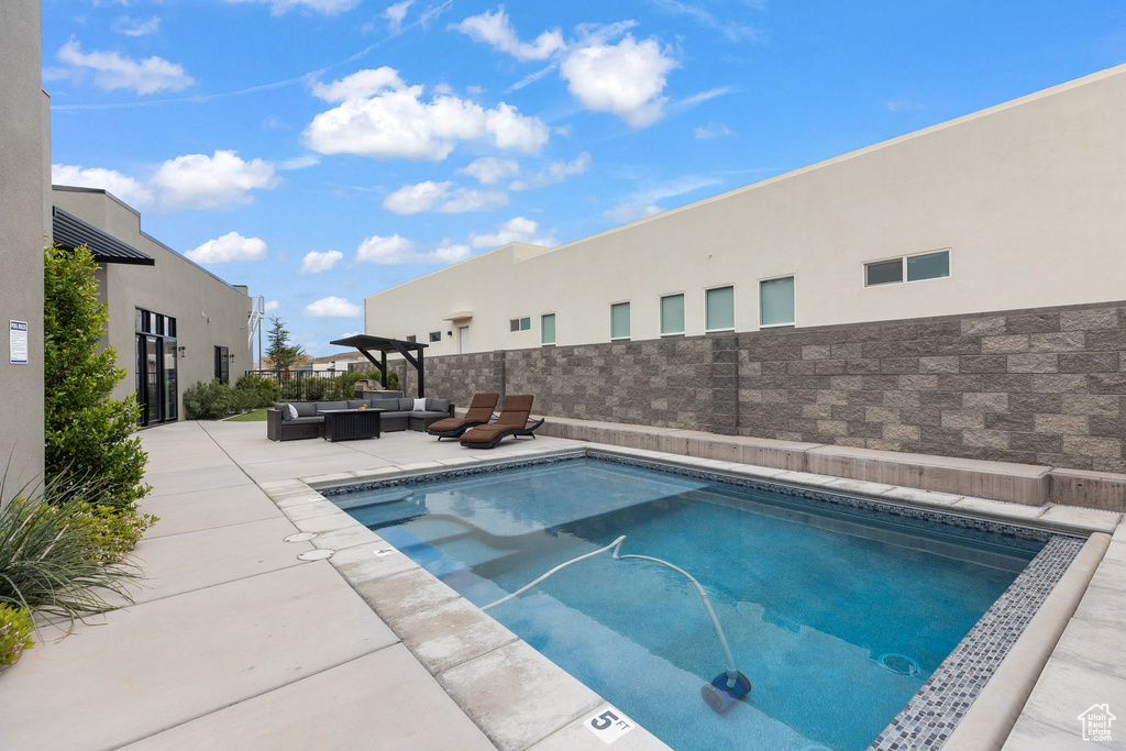 View of pool with an outdoor hangout area and a patio