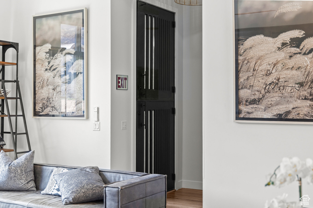 Hallway featuring wood finished floors and baseboards