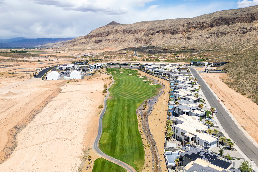 Aerial overview of property's location featuring a mountain backdrop, nearby suburban area, and a local golf course