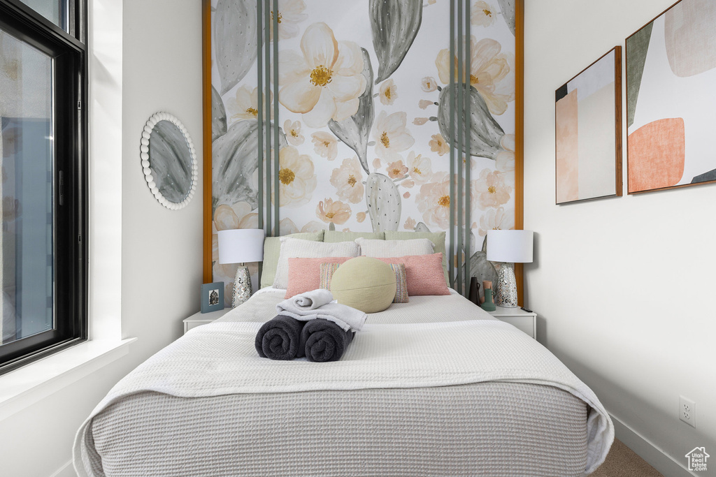 Carpeted bedroom featuring baseboards