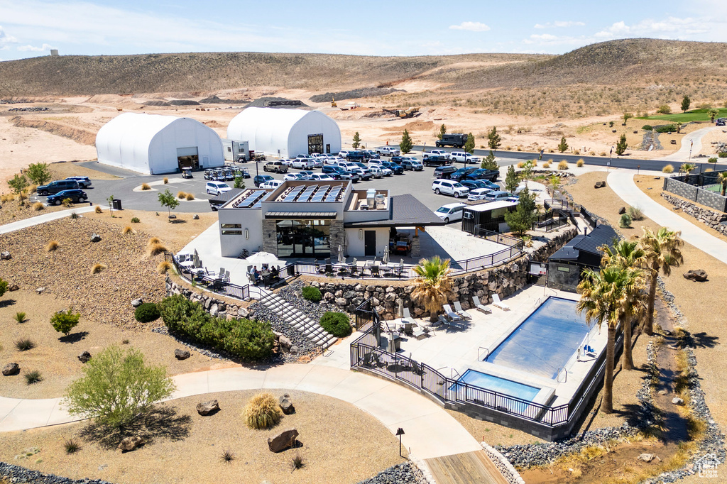 Drone / aerial view of a mountainous background and a pool