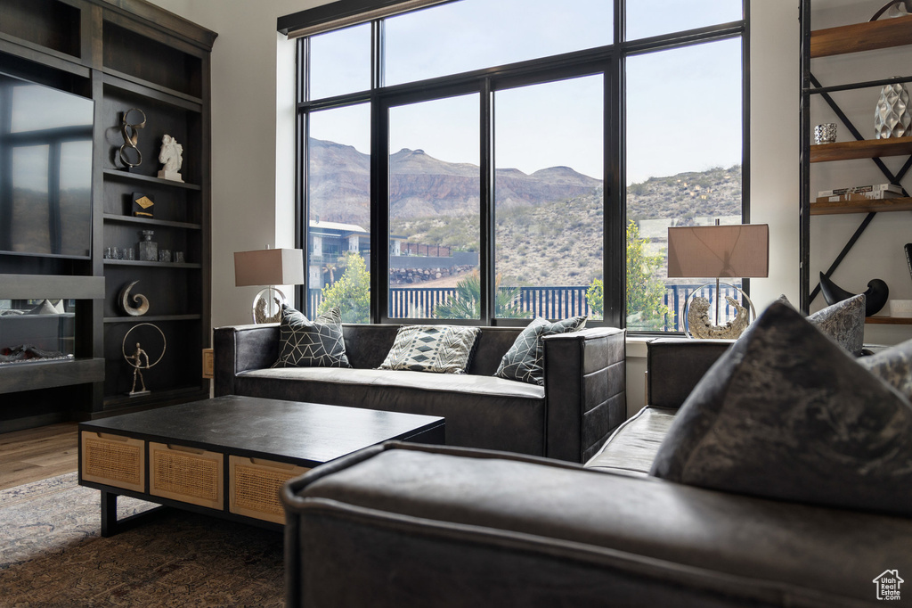 Living room with a mountain view and dark wood-style floors