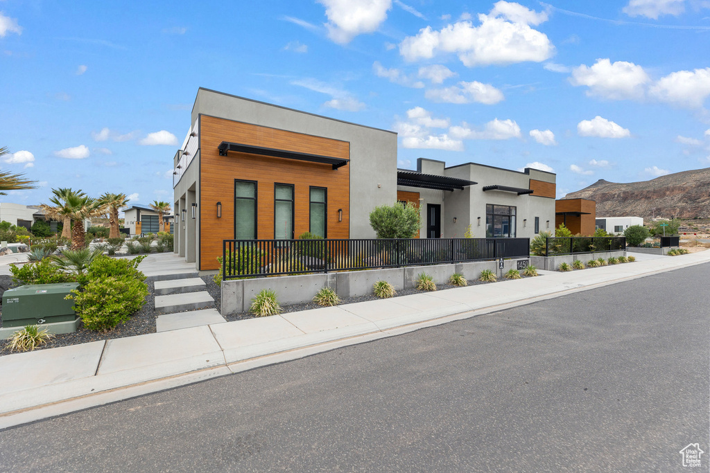 Modern home featuring a mountain view, a residential view, and stucco siding